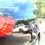 Before and after photographs of a damaged black Volkswagon Jetta that was repaired by Elite Paint & Body Shop in West Palm Beach, Florida.